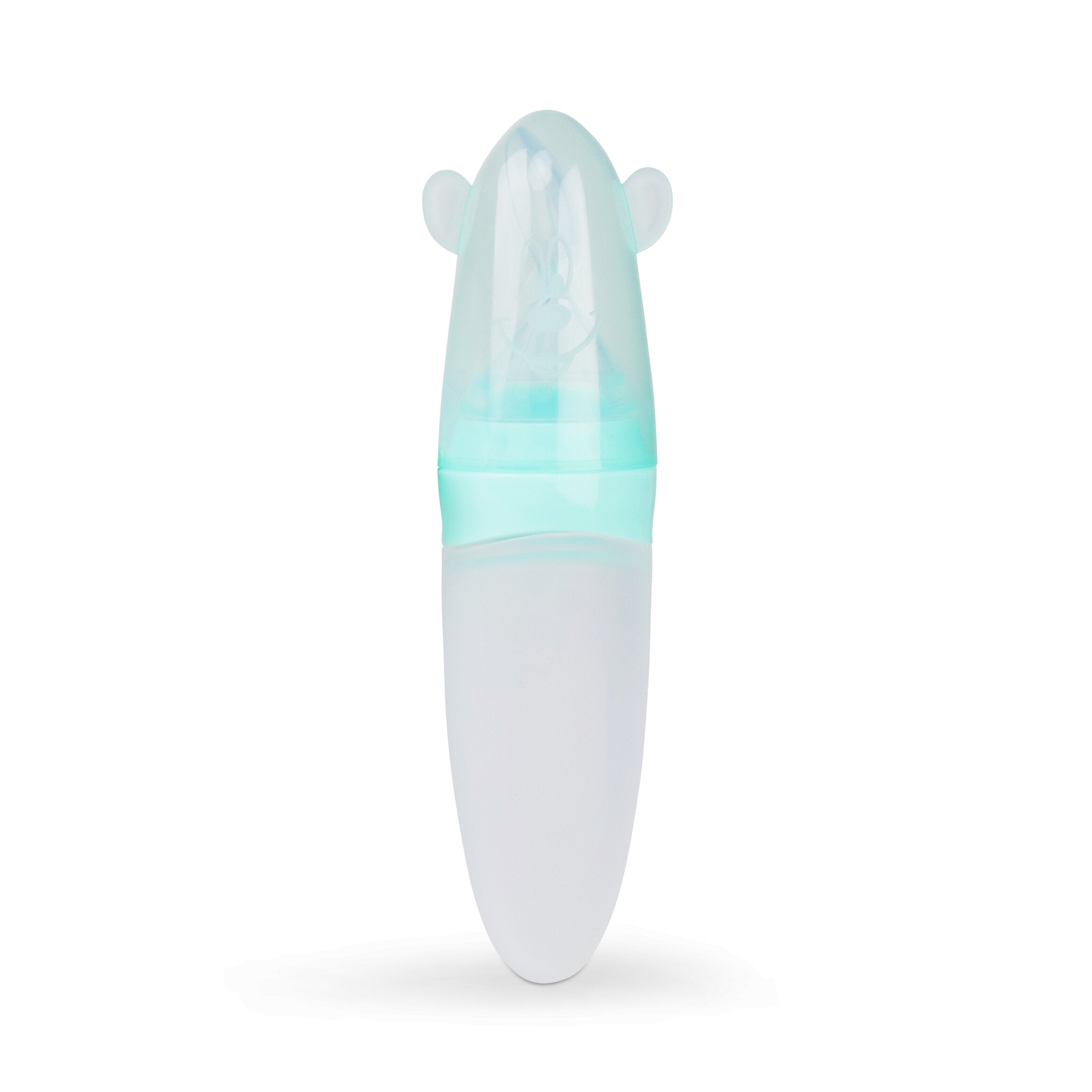 Een foto van de groene siliconen lepel met de beschermdop die rechtop staat. Op de dop is een smiley face uitgebeeld.